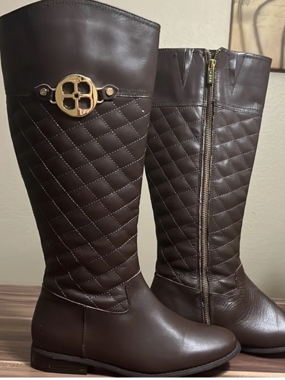 Iman Brown Quilted Knee-High Riding Boots with gold logo medallion